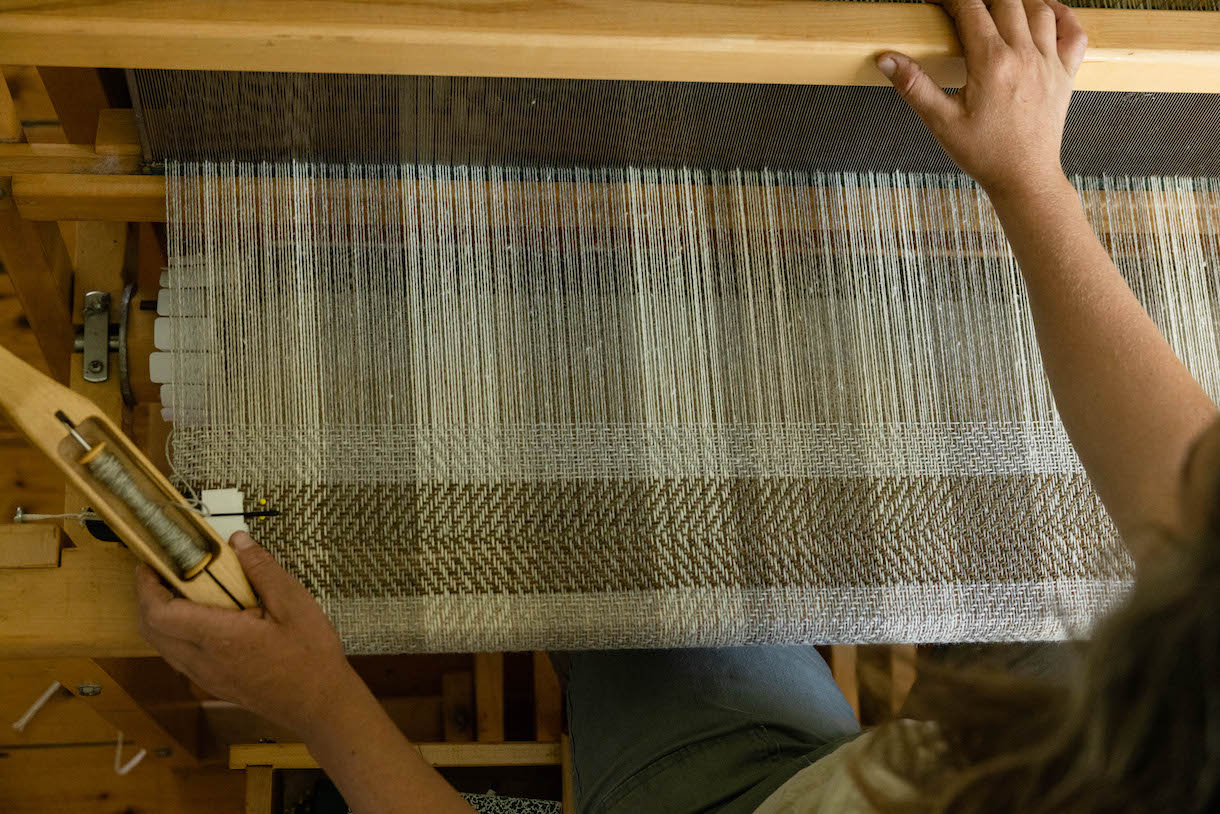 Hands on a loom.